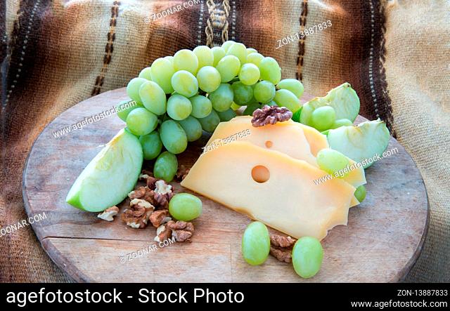 Cheese and grapes  - snack or dessert  and pieces of walnuts