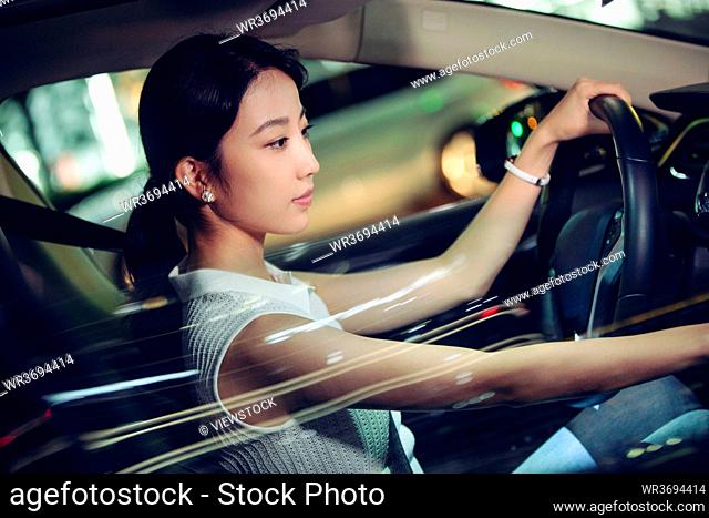 Beautiful young woman driving a car