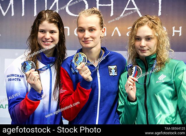 RUSSIA, KAZAN - APRIL 21, 2023: Silver medalist Maria Kameneva, gold medalist Arina Surkova, and bronze medalist Yelizaveta Klevanovich (L-R) pose during an...