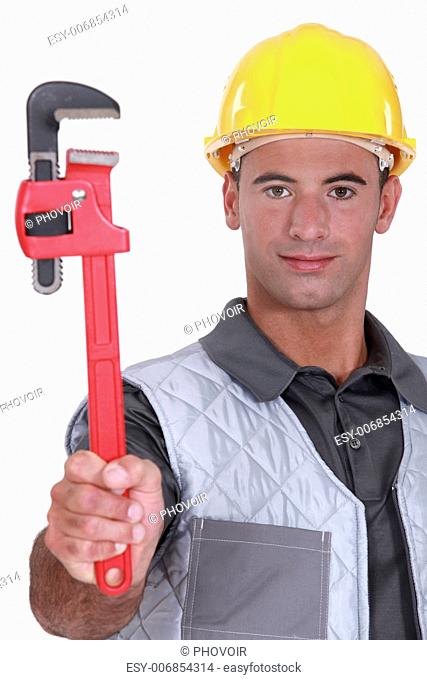 Man with a heavy duty adjustable pipe wrench