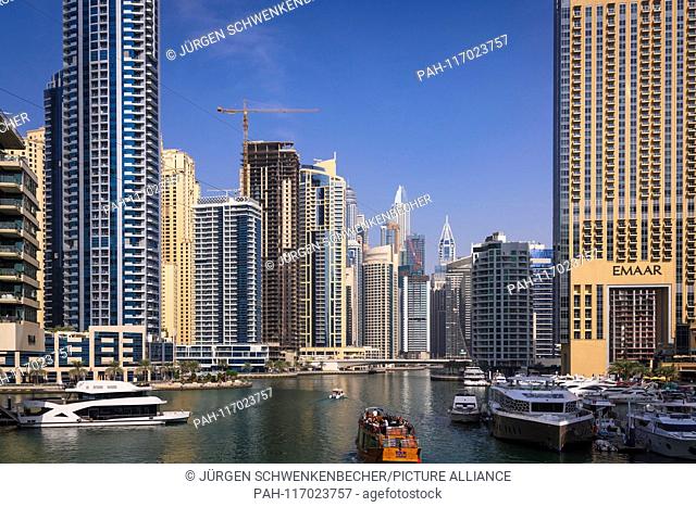 The skyscrapers are densely packed in the exclusive district of Marina Dubai. The impressive skyscrapers crowd around Marina Bay
