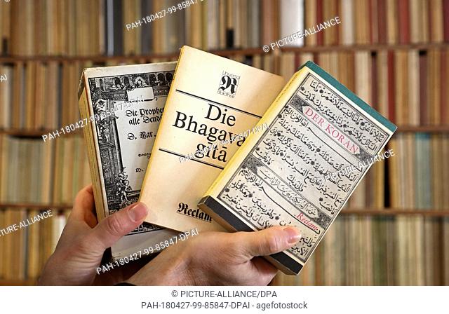 19 April 2018, Rostock, Germany: Bookseller Frank Weisleder shows from the Reclam series a three-part Bible (l-r), the ""Bhagavad gita"", a kind of Indian Bible