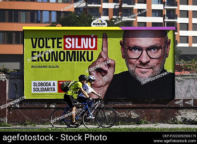 Cyvlists past an election poster of Richard Sulik, leader of the political party Freedom and Solidarity, September 29, 2023, Bratislava, Slovakia