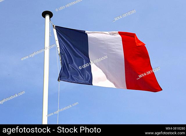 French flag in front of a blue sky