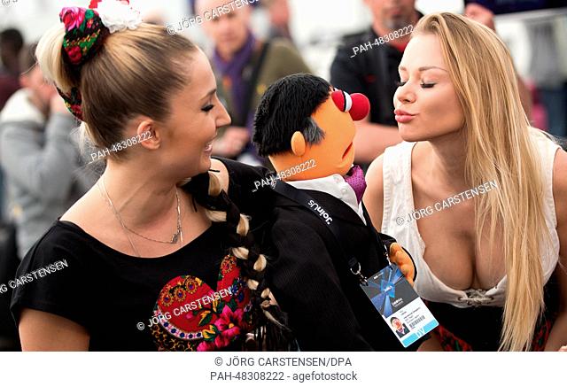 Singer Cleo (L, representing Poland), the doll Terry Vision and a dancer have fun during a press conference at the Eurovision Song Contest 2014 in Copenhagen