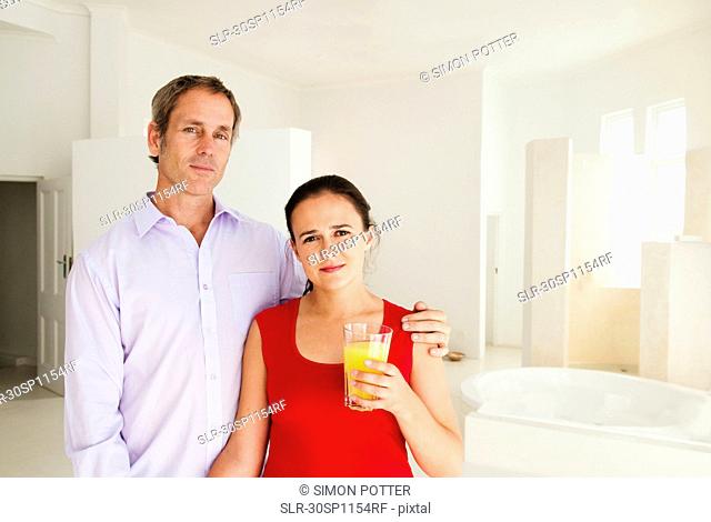 Couple at home in bright room