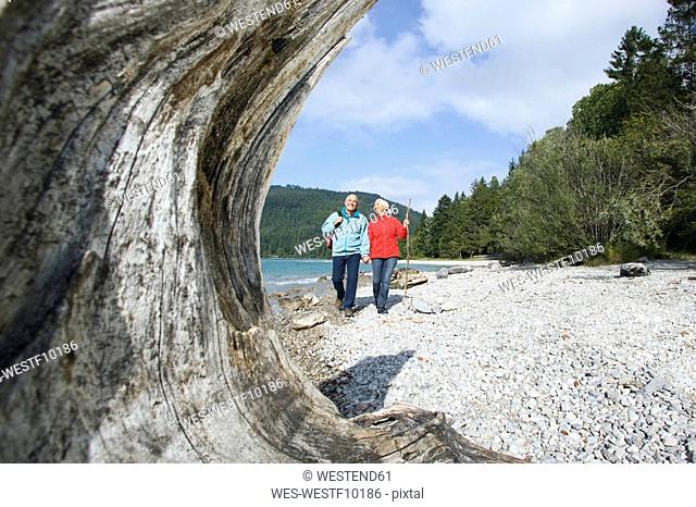 Germany, Bavaria, Walchensee, Senior couple hiking on lakeshore