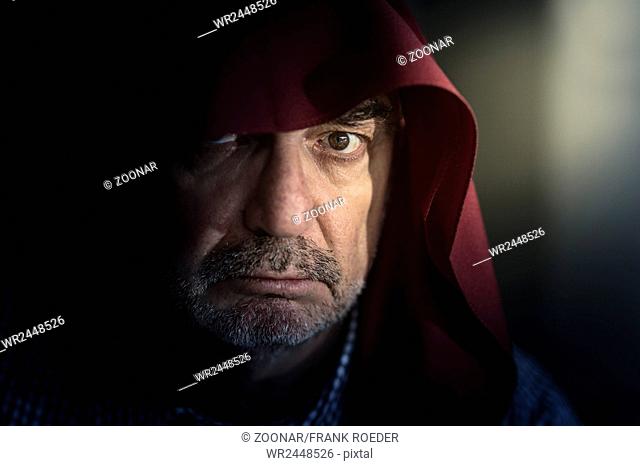 Portrait of an old man with a red hood