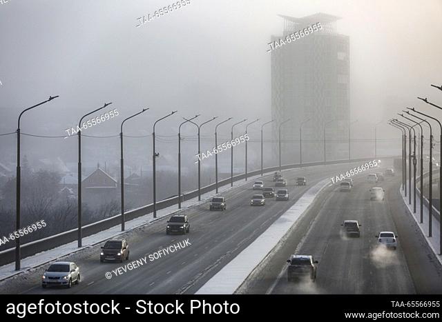 RUSSIA, OMSK - DECEMBER 8, 2023: Cars move along Frunzensky Bridge in the Siberian city of Omsk on a frosty winter day. According to Russia's weather...