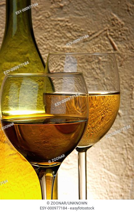 Glasses of white wine and bottle