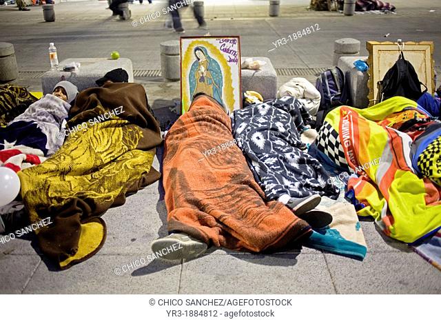 Pilgrims sleep in the street by an image of the Our Lady of Guadalupe virgin in Mexico City, December 11, 2010  Hundreds of thousands of Mexican pilgrims...