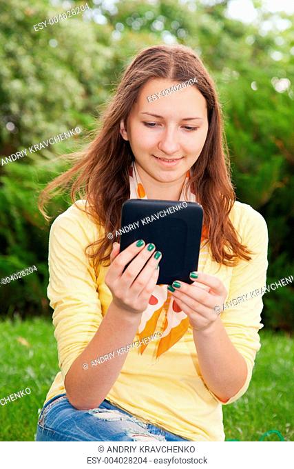 Teen girl reading electronic book