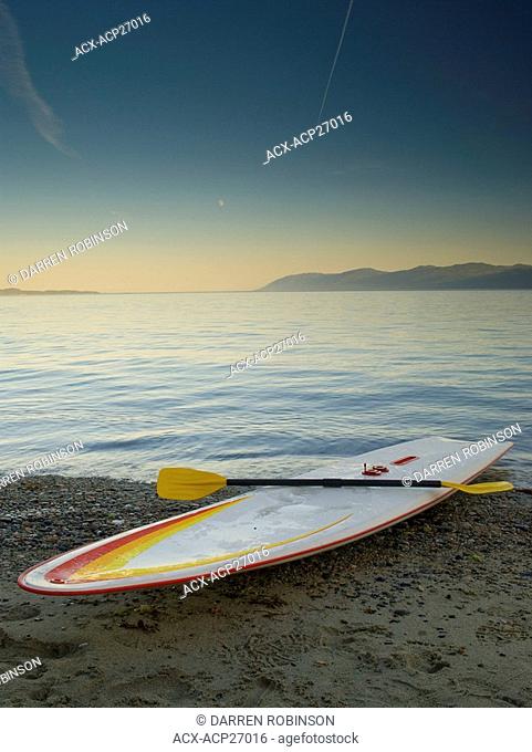 Longboard on the shore of Palm Beach near Powell River, on the beautiful Sunshine Coast of British Columbia, Canada