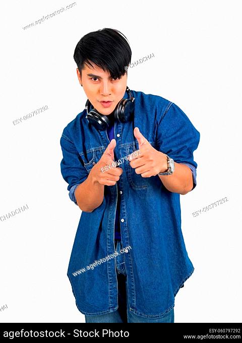 Young asian man dress in jean with headphone pointing finger in front direction. Portrait on white background with studio light. Close Up