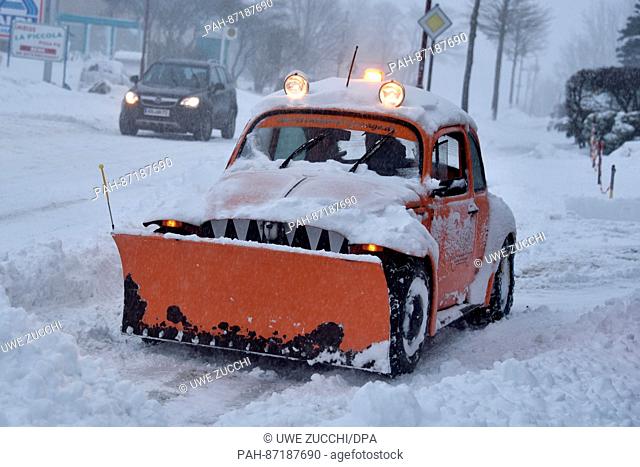 A man clears a street using a VW Beetle that was rebuilt as a snowplough in Usseln, Germany, 13 January 2017. The storm front 'Egon' did not cause any major...