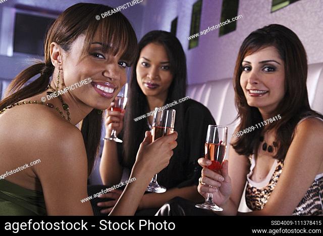 Portrait of multi-ethnic women holding cocktails