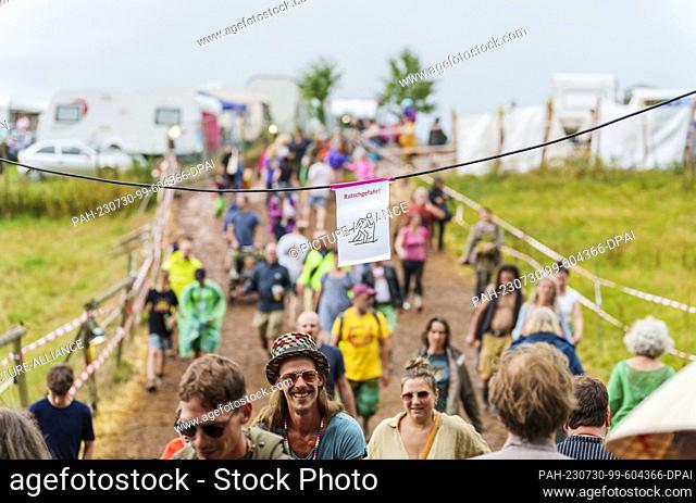 29 July 2023, Hesse, Breitenbach: A note warns festival-goers of the danger of slipping on the grounds. The ""Burg Herzberg Festival"" is a music and literature...