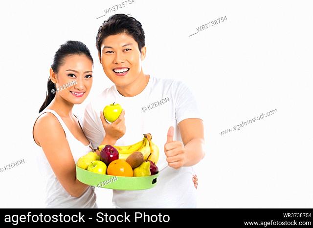 Chinese Asian couple eating healthy fruits