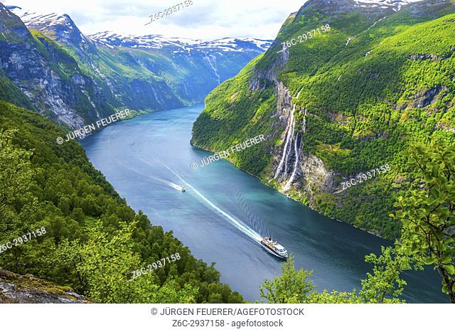 view to the Seven Sisters waterfall and the Geirangerfjorden with a cruise ship of Hurtigruten and a ferry, mountain panorama, Norway
