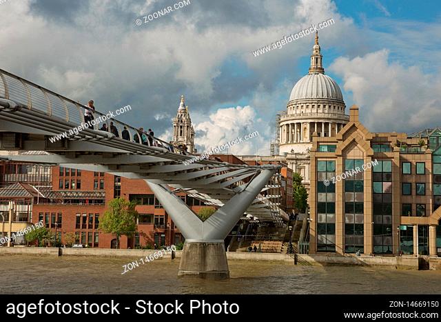 LONDON, UK - SEPTEMBER 08, 2017: St Pauls Cathedral and the Millennium Bridge in London, United Kingdom during a cloudy day
