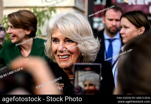 30 March 2023, Berlin: Royal consort Camilla greets her fans together with Elke Büdenbender (l) during a visit to Refugio Berlin on the second day of the trip...