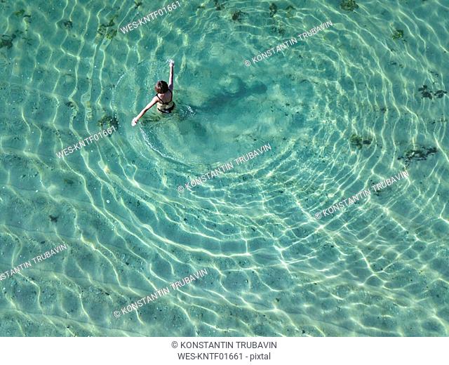 Indonesia, Bali, Melasti, Aerial view of Karma Kandara beach, one woman in water