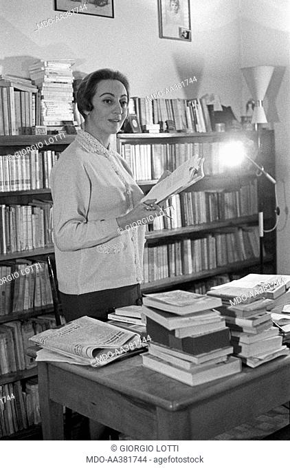 Maria Luisa Garoppo with a book in her hands. Italian ex tobacconist Maria Luisa Garoppo holding an open book in her hands