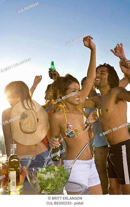 A group of young giels dancing at a foam party, beach party, Nissi