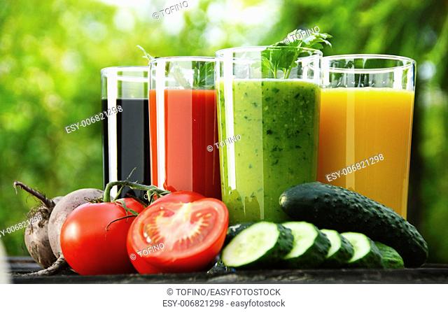 Glasses with fresh vegetable juices in the garden. Detox diet