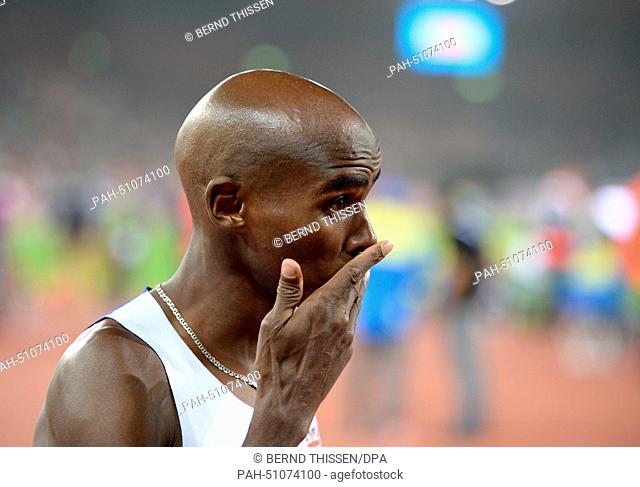 Winner Mohamed ""Mo"" Farah (C) from Great Britain reacts after winning the men's 10'000m final race at the European Athletics Championships 2014 at the...