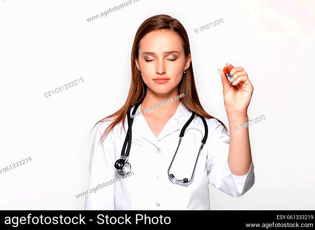 woman doctor hand with pen pointing on something. focus on hand