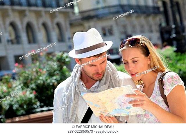 Couple of tourists looking at city tour map