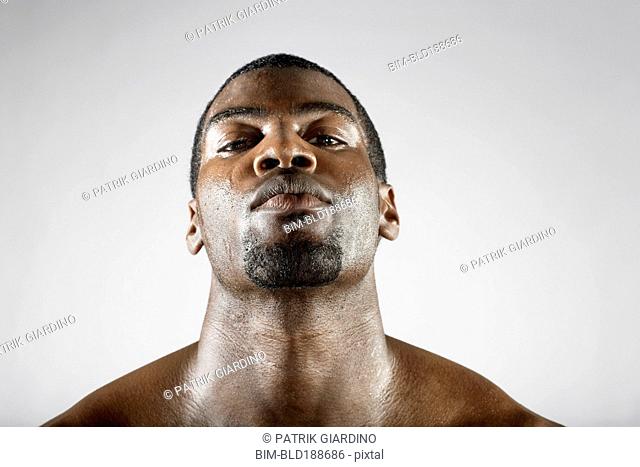 Serious African man sweating