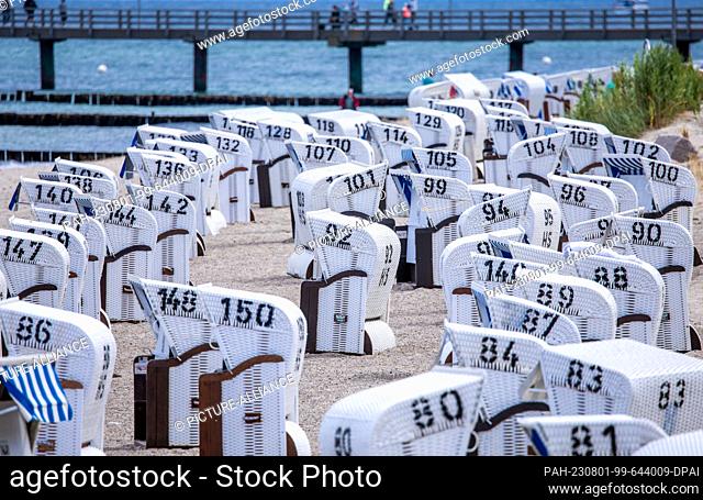 01 August 2023, Mecklenburg-Western Pomerania, Kühlungsborn: Most of the beach chairs on the Baltic coast are empty. The weather in northern Germany is...