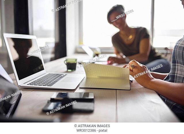 Women sitting at table in office