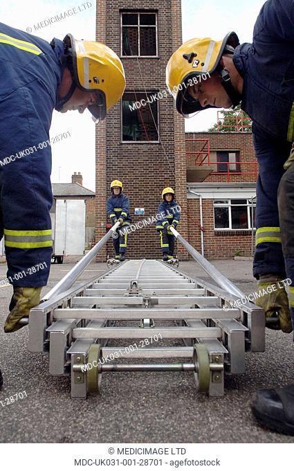 Firefighters at Hertfordshire Fire & Rescue Service, UK, prepare to climb up a ladder. . In December 2005, HFRS dealt with what is thought to Britainâ€™s...
