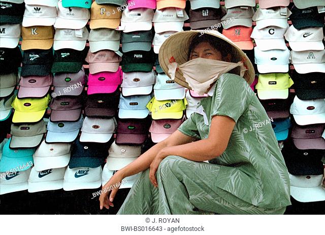 Vietnamese female hat seller, wearing veil and non, Vietnam