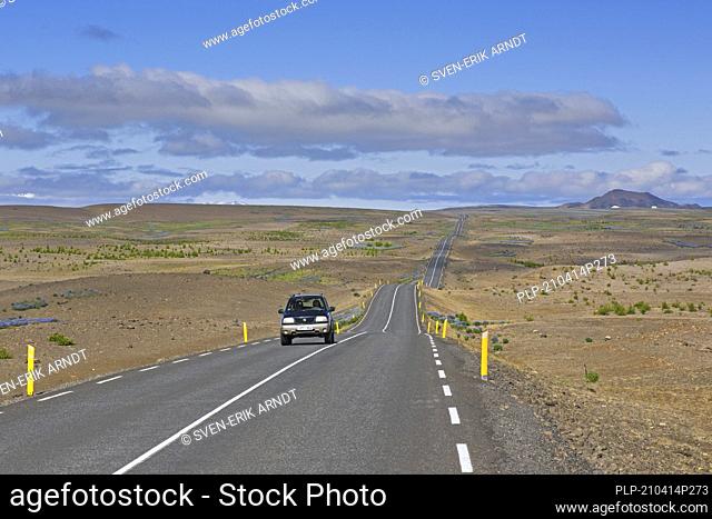 Lonely car driving the Highway 85 / Norðausturvegur / Route 85 in summer, primary road in Nordurland eystra, northeastern Iceland
