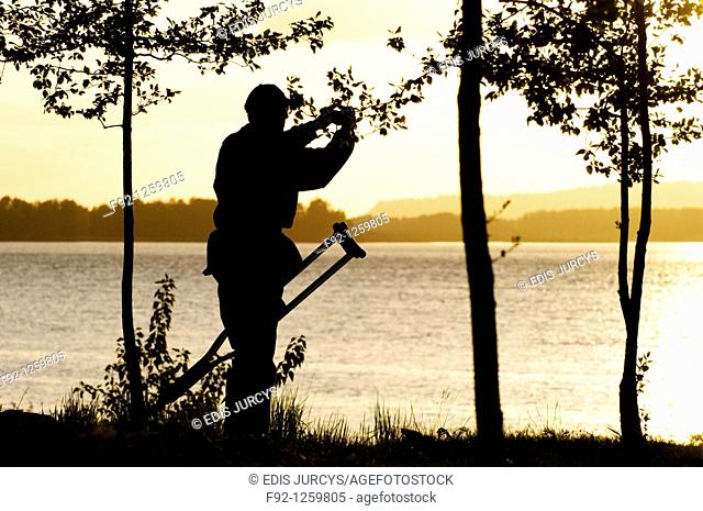 Disable man is taking a photograph of the sunset at the Columbia river, Oregon, USA