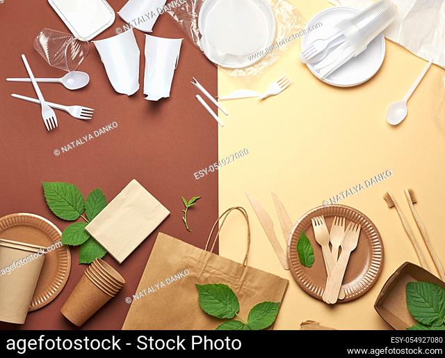 non-degradable plastic waste from disposable tableware and a set of dishes from environmental recycled materials on a brown background