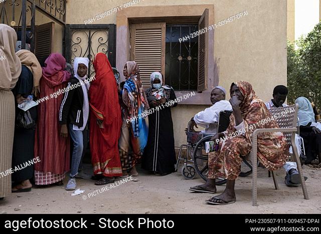 04 May 2023, Egypt, 6th of October City: A picture made available on 8 May 2023 shows Sudanese people waiting outside the site of a medical convoy for newcomers...
