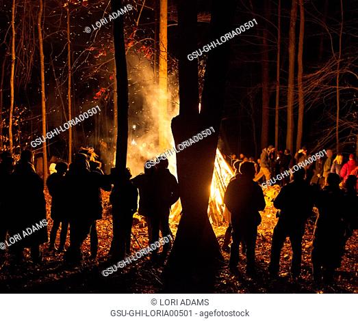 Group of People Standing Around Bonfire at Night