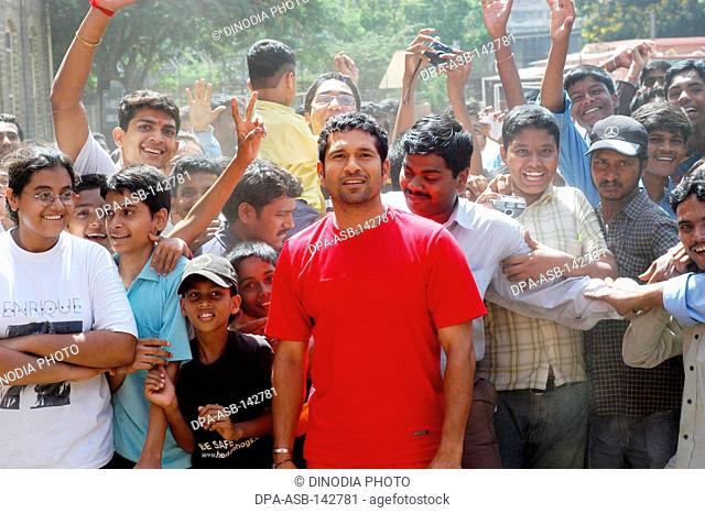 Indian cricket star Sachin Tendulkar is surrounded by his fans ; Bombay now Mumbai ; Maharashtra ; India NO MR