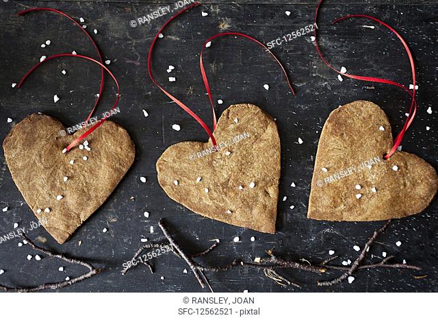 Heart shaped Christmas ginger biscuits with decorative ribbon