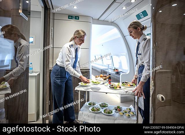 04 May 2023, Brandenburg, Schönefeld: Flight attendants serve sushi and Ceaser salad as appetizers on board the Airbus A350-900 ""Konrad-Adenauer"" of the...