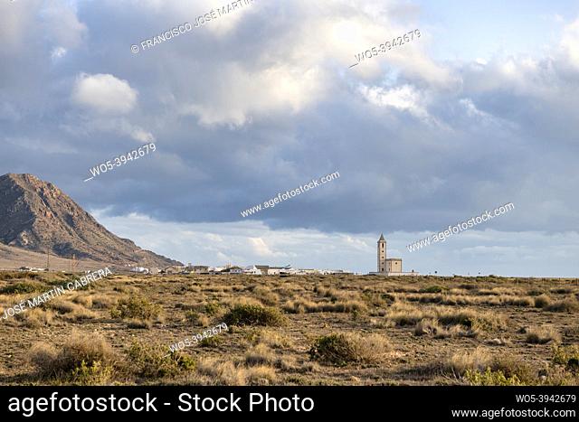 Small neighborhood located between sea and mountains, Las Salinas of Cabo de Gata, with its image of church visible from desert