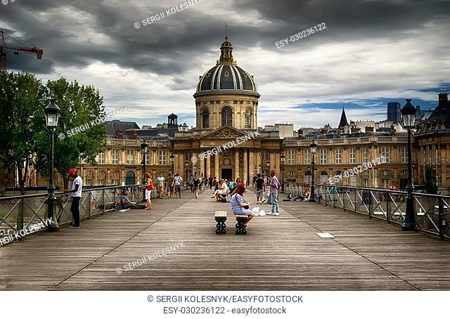 View on facade of Institut de France in Paris from Pont des Arts at cloudy day
