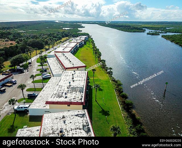 Business Buildings in a Row on the Riverfront Aerial Drone Shot Nature Outdoors Daytime