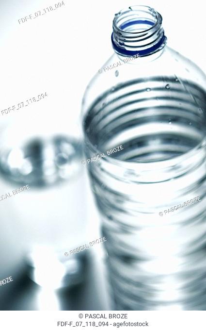 Close-up of a water bottle with a glass of water