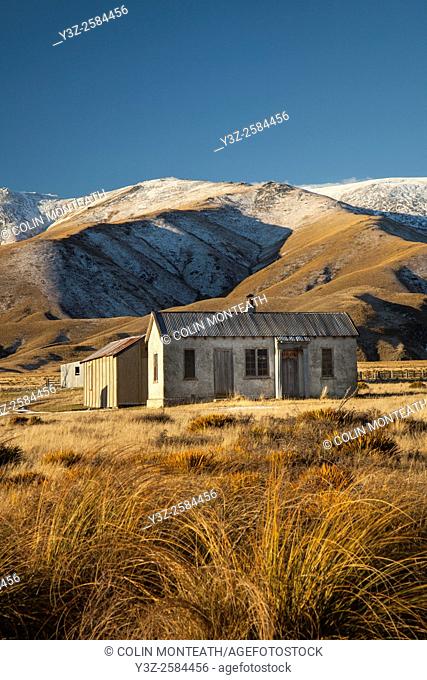 1939 farm cottage (still in use as tea room for shearers), early winter snowfall on Hawkdun Range, St Bathans, Central Otago
